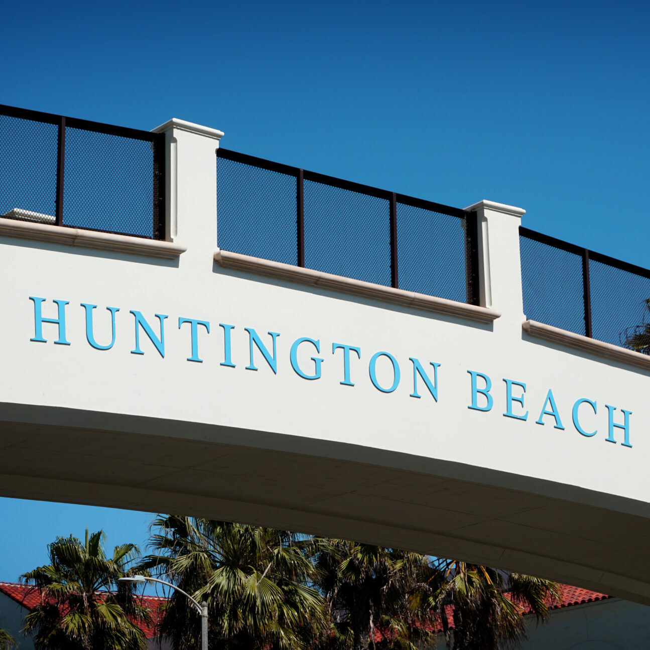 huntington beach sign on bridge over pacific coast highway